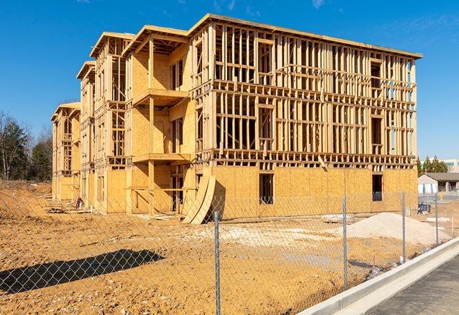 a close-up of temporary chain link fences enclosing a job site, signaling progress in the project's development in Sheldon, MO